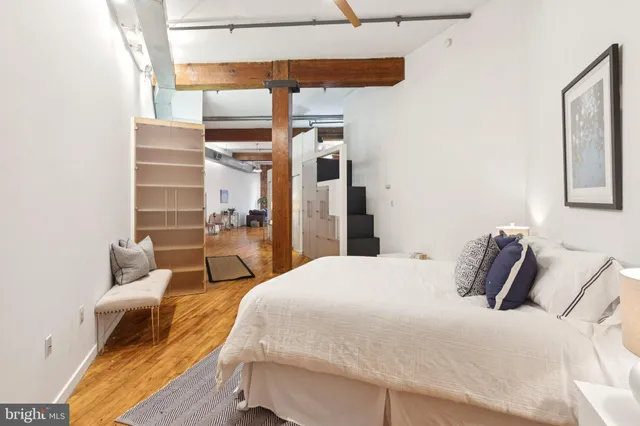 a bedroom with a bed and balcony