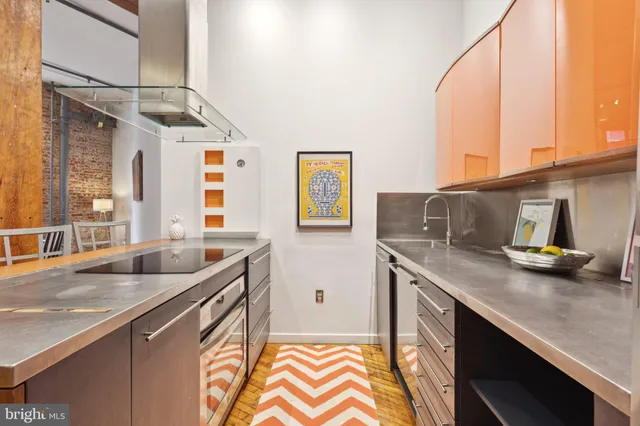 a kitchen with stainless steel appliances a sink and a cabinets
