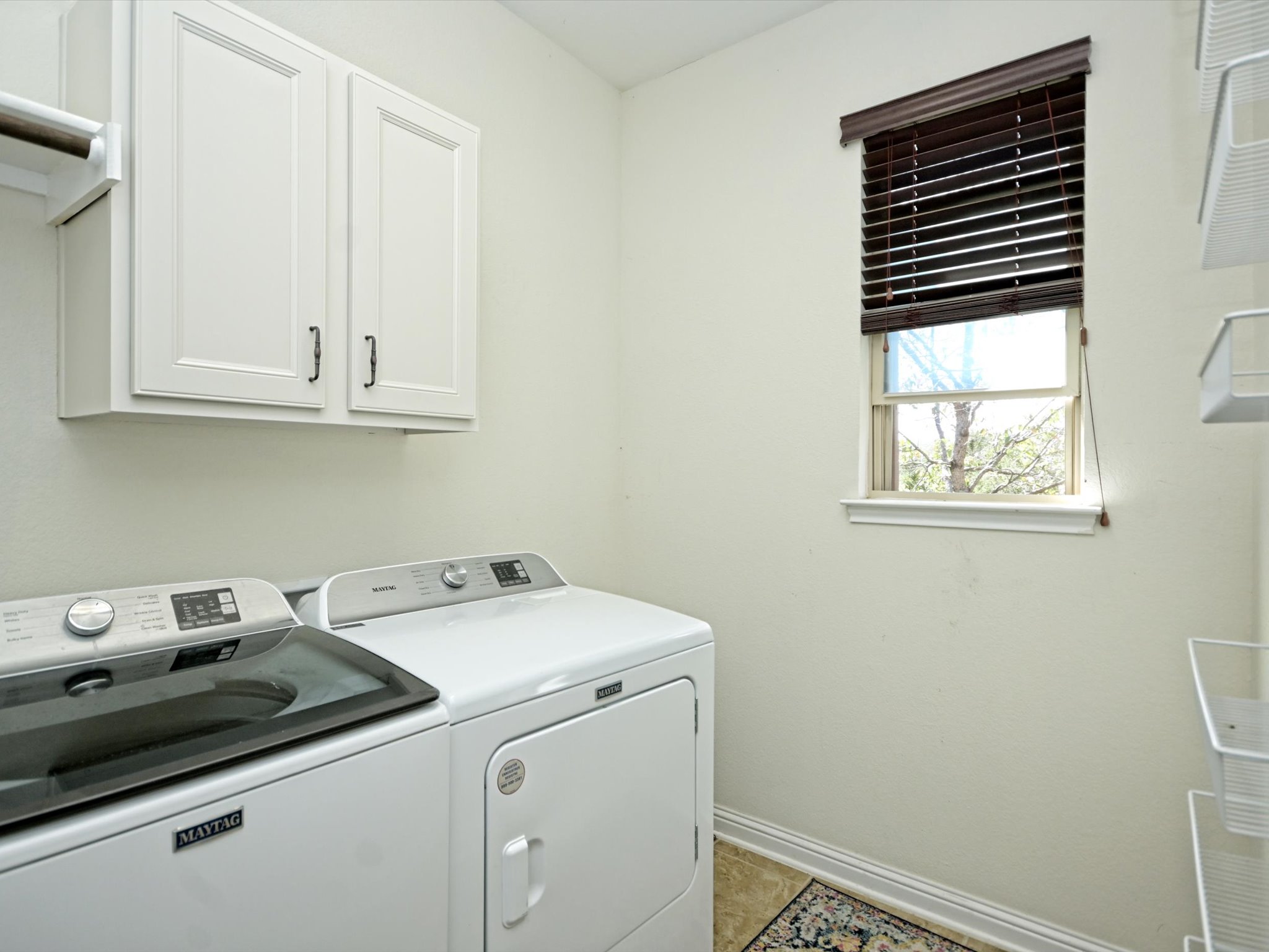 201 Bellagio Drive Austin, TX 78734 - Photo 26 of 31 The in home laundry room comes with cabinetry storage and a window.