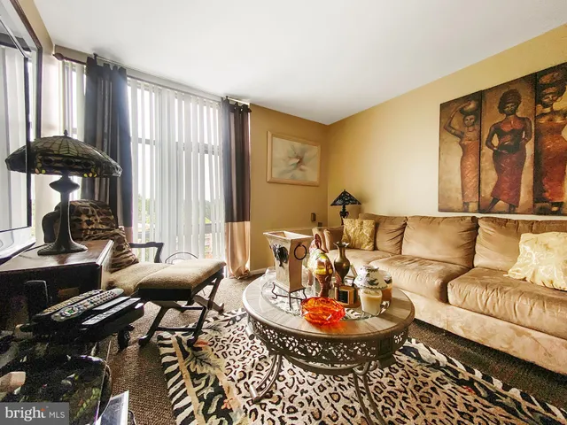 a living room with furniture and large windows