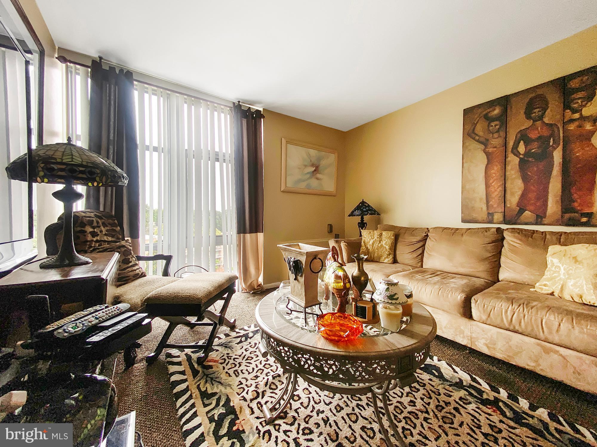 3600 Conshohocken Avenue, Unit 909 Philadelphia, PA 19131 - Photo 13 of 22 a living room with furniture and large windows