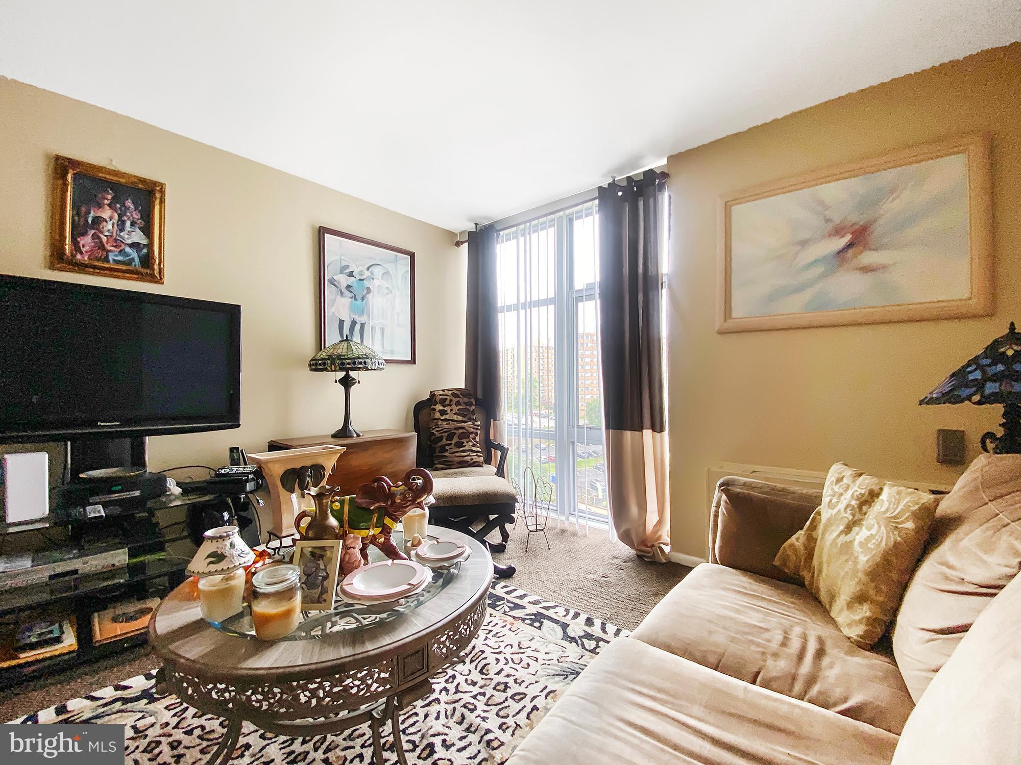 3600 Conshohocken Avenue, Unit 909 Philadelphia, PA 19131 - Photo 14 of 22 a living room with furniture and a flat screen tv
