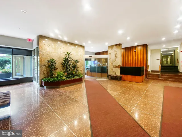 a view of a lobby with black carpet