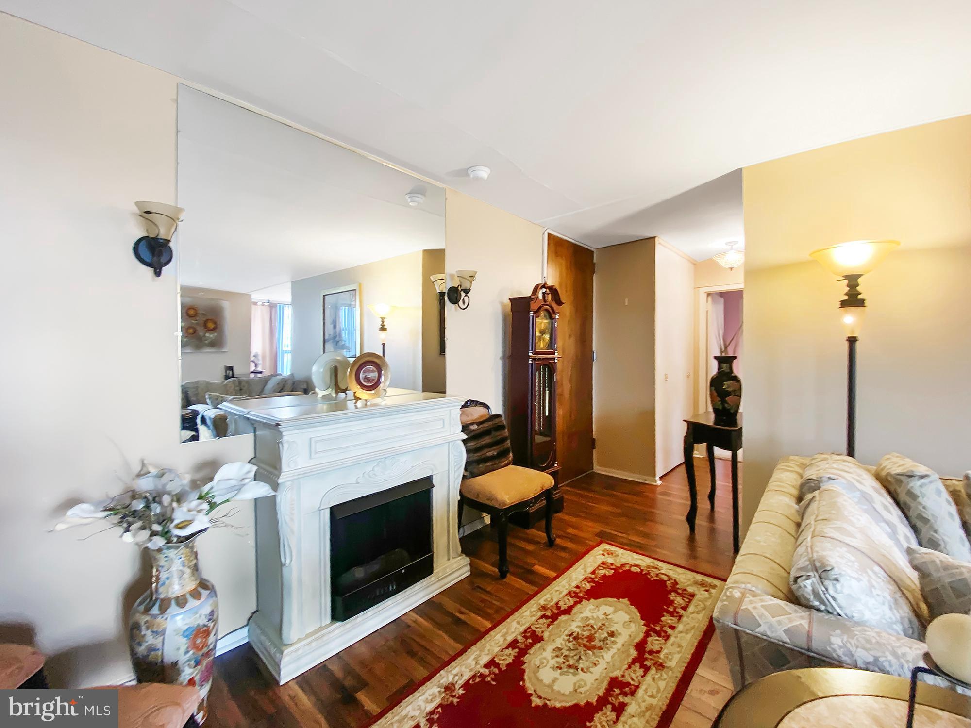 3600 Conshohocken Avenue, Unit 909 Philadelphia, PA 19131 - Photo 2 of 22 a living room with furniture and a fireplace