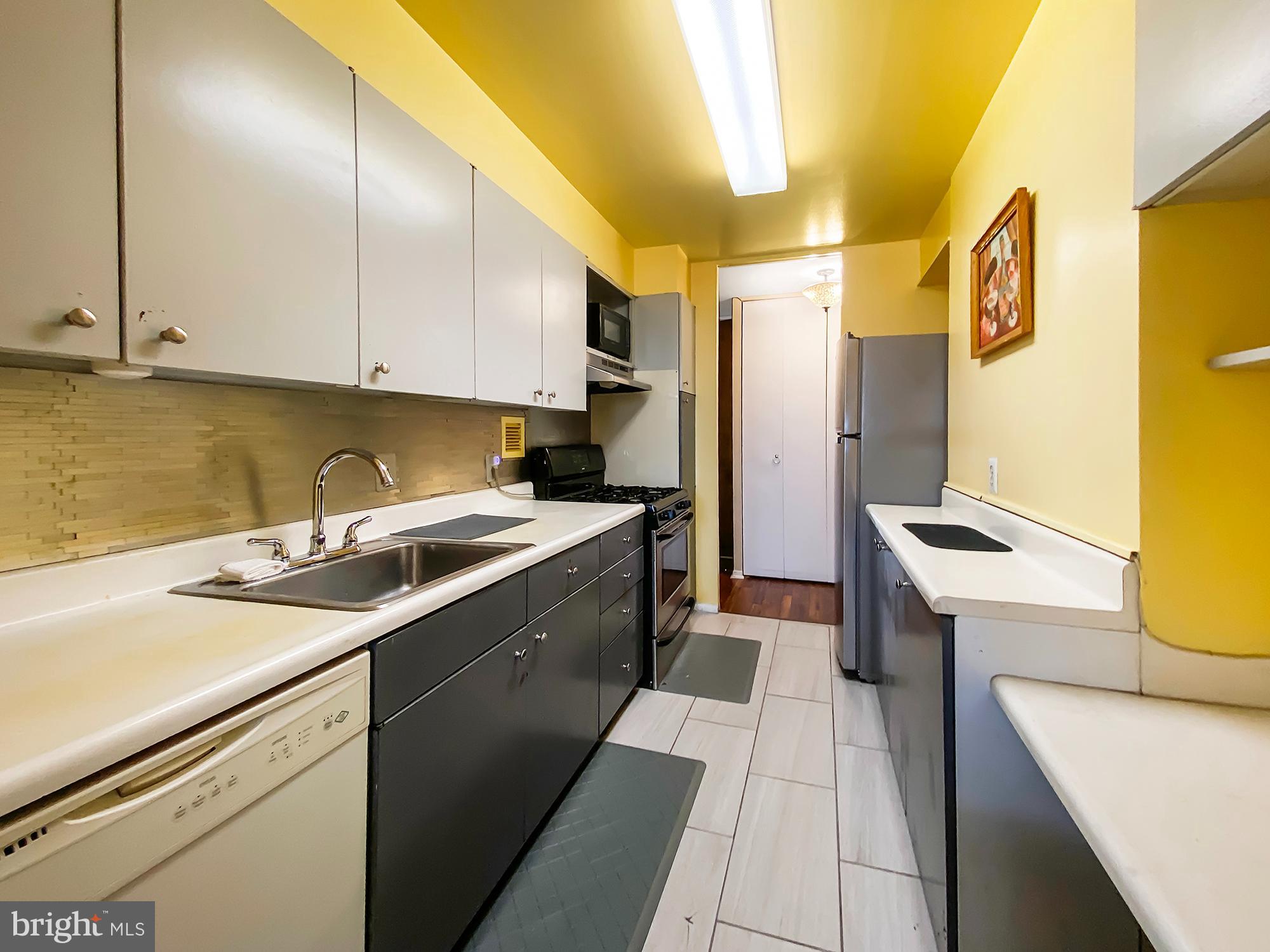 3600 Conshohocken Avenue, Unit 909 Philadelphia, PA 19131 - Photo 3 of 22 a kitchen that has a sink and a stove