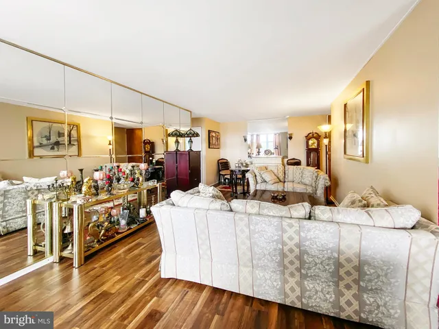 a living room with lots of furniture and a wooden floor
