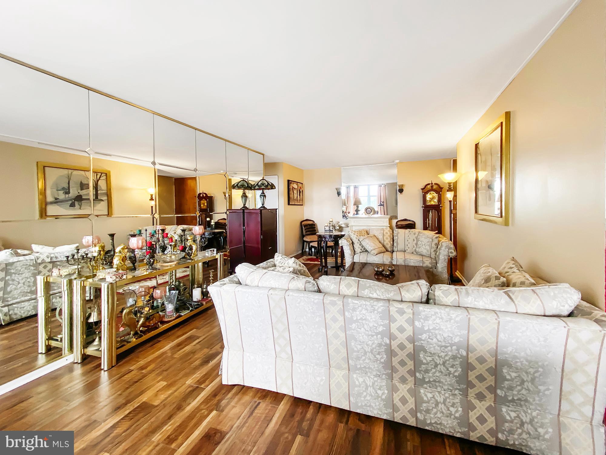 3600 Conshohocken Avenue, Unit 909 Philadelphia, PA 19131 - Photo 6 of 22 a living room with lots of furniture and a wooden floor