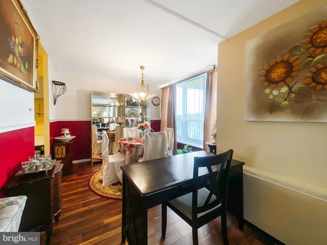 a view of a dining room with furniture and a potted plant