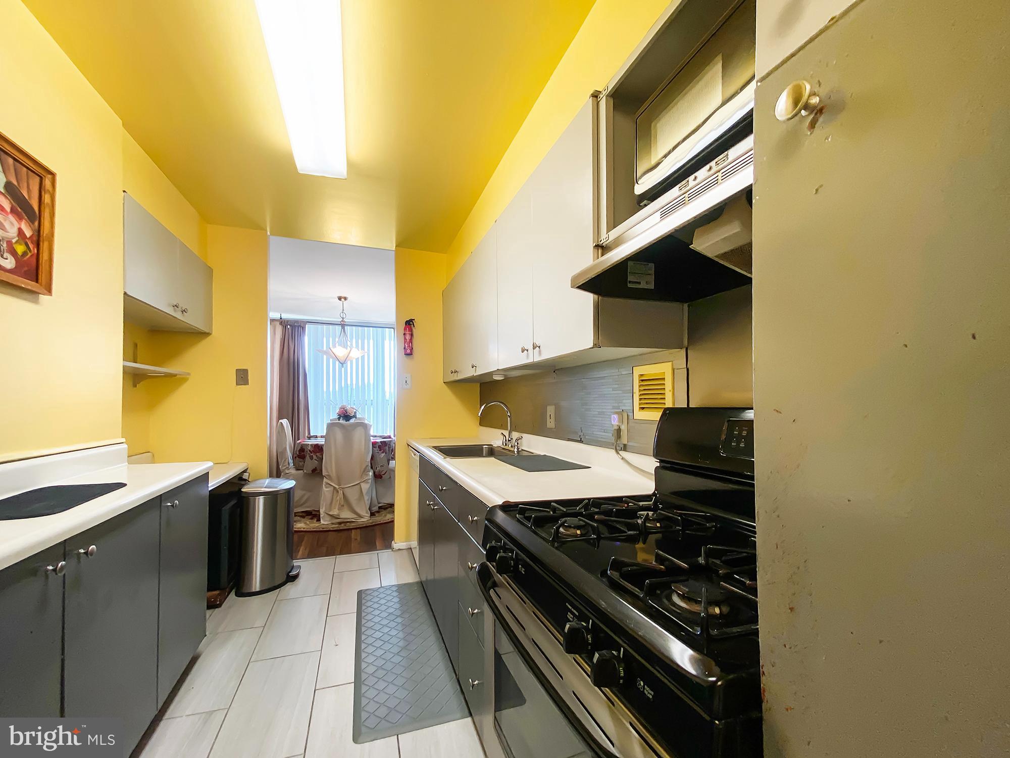 3600 Conshohocken Avenue, Unit 909 Philadelphia, PA 19131 - Photo 10 of 22 a kitchen with a stove and a sink