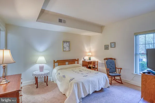a bedroom with a bed and a lamp on table