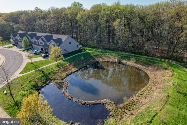 an aerial view of a house with a yard and lake view