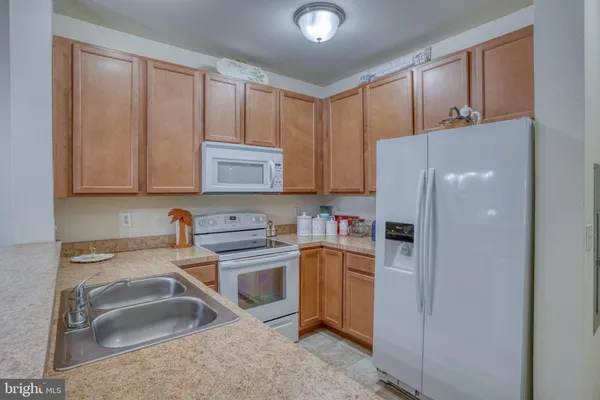 a kitchen with stainless steel appliances granite countertop a refrigerator sink and cabinets