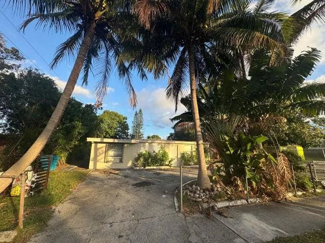 a view of a yard with wooden fence