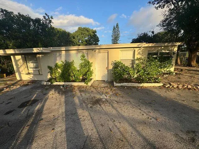 a view of a swimming pool with a patio and plants