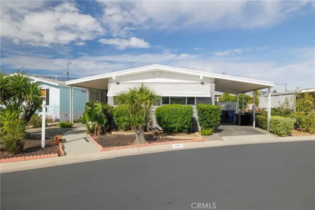 a view of a patio with a table and chairs under an umbrella
