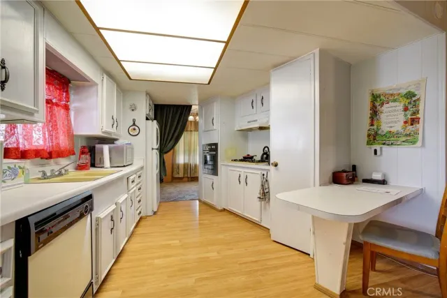 a bedroom with a bed a chandelier and a bookshelf