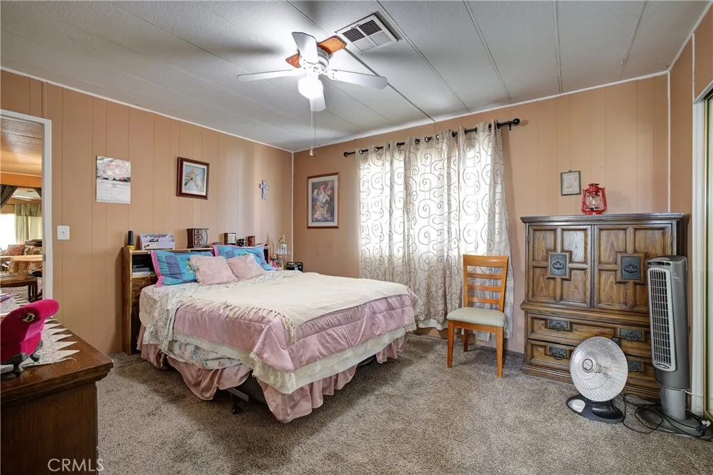 3700 Buchanan Street, Unit 105 Riverside, CA 92503 - Photo 17 of 30 a bedroom with a bed a chandelier and a bookshelf