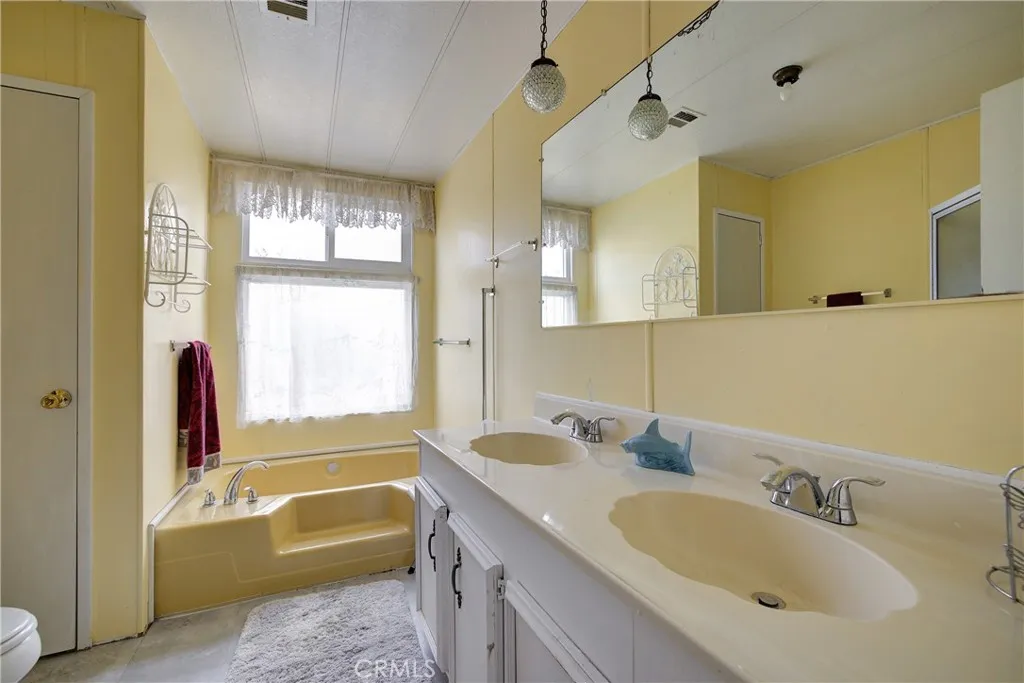3700 Buchanan Street, Unit 105 Riverside, CA 92503 - Photo 18 of 30 a bathroom with a tub sink and mirror