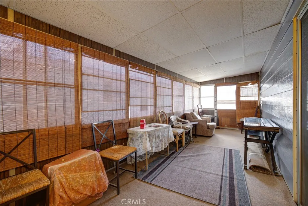 3700 Buchanan Street, Unit 105 Riverside, CA 92503 - Photo 23 of 30 a living room with furniture and large windows