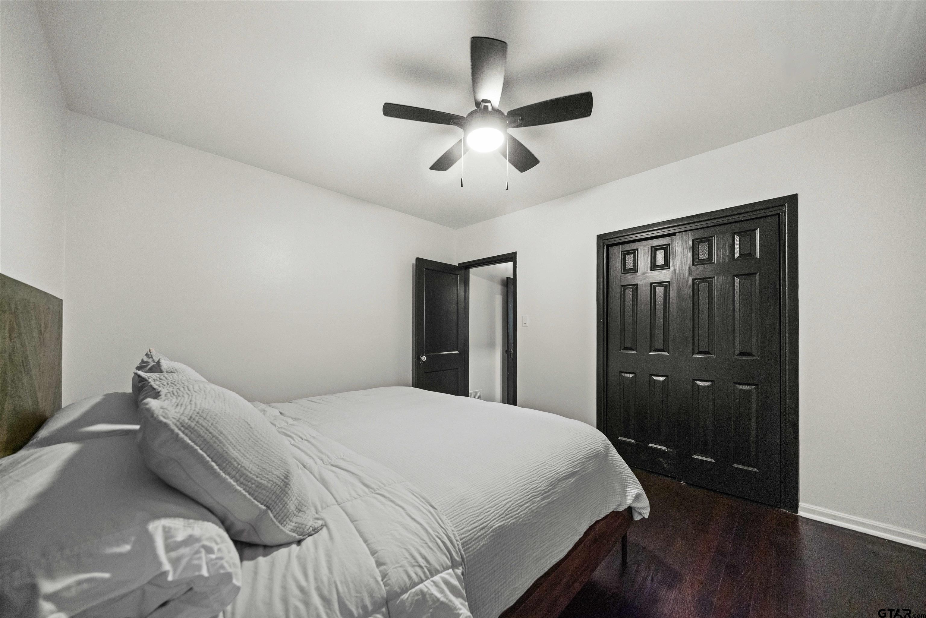 400 Lindsey Lane Tyler, TX 75701 - Photo 15 of 25 a bedroom with a bed and a chandelier