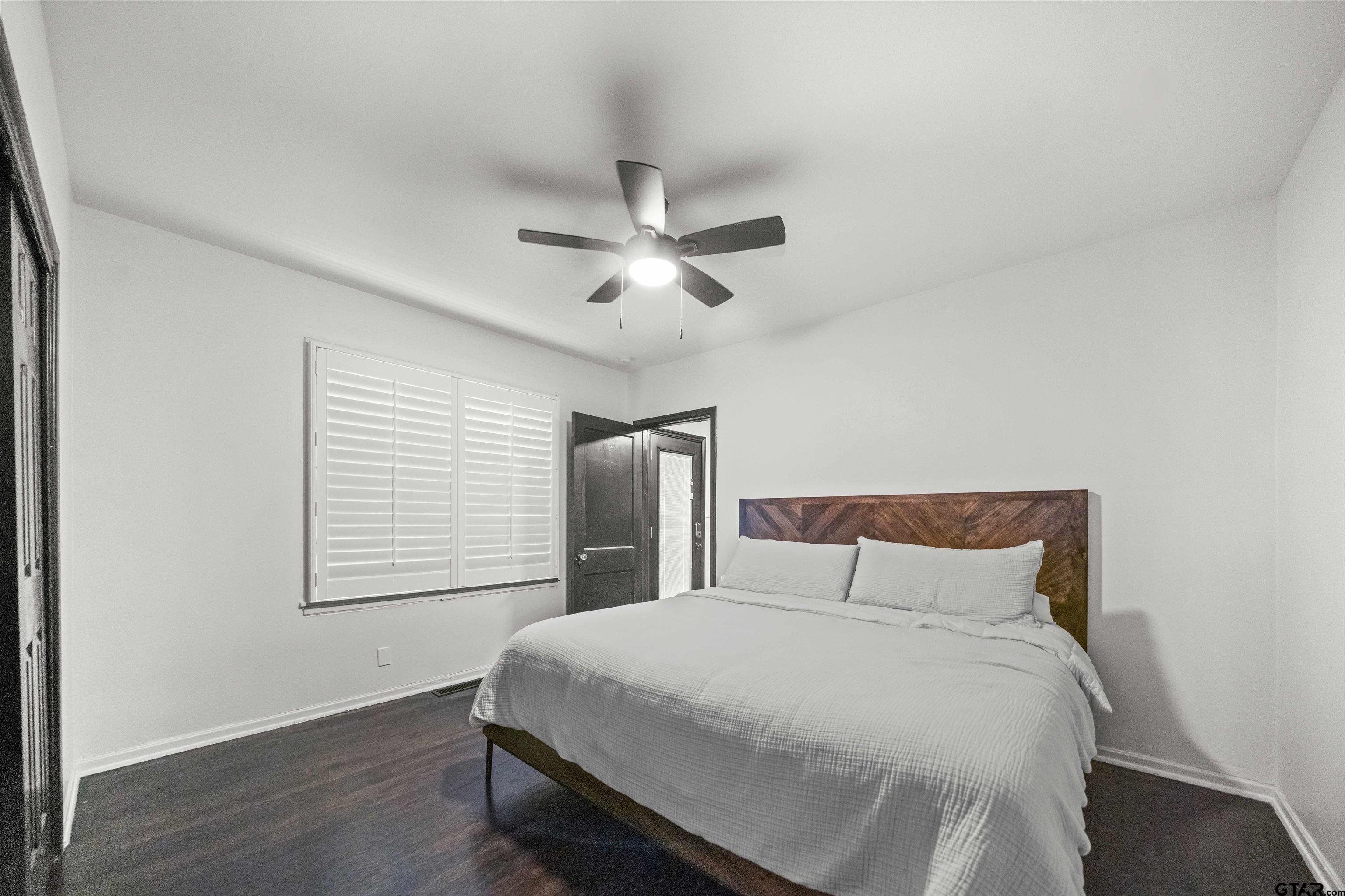 400 Lindsey Lane Tyler, TX 75701 - Photo 19 of 25 a bedroom with a large bed chandelier and a window