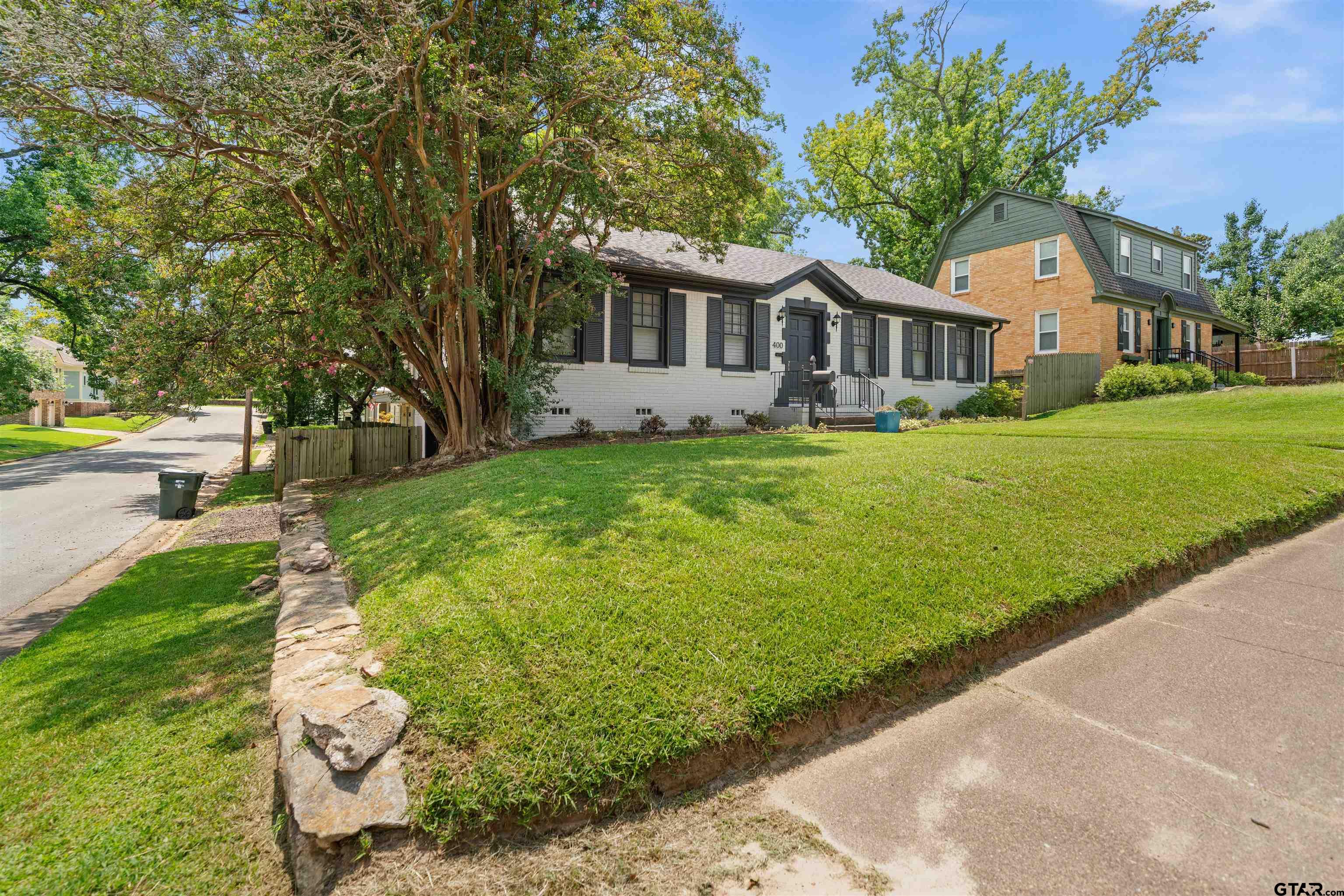 400 Lindsey Lane Tyler, TX 75701 - Photo 3 of 25 a front view of a house with a garden