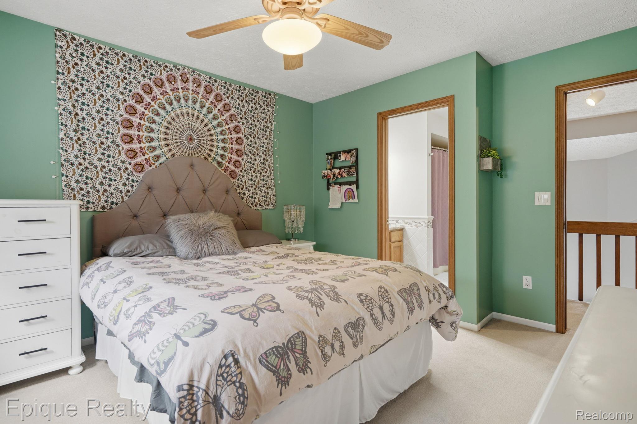 6607 Ridgeview Drive Clarkston, MI 48346 - Photo 18 of 25 Bedroom with light carpet, ceiling fan, and ensuite bath