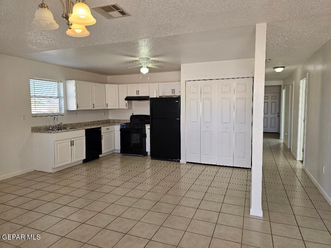 401 South 5th Street Anthony, TX 79821 - Photo 6 of 26 a kitchen with stainless steel appliances granite countertop a refrigerator and a sink