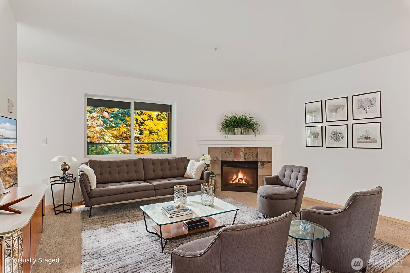 a living room with furniture and a fireplace