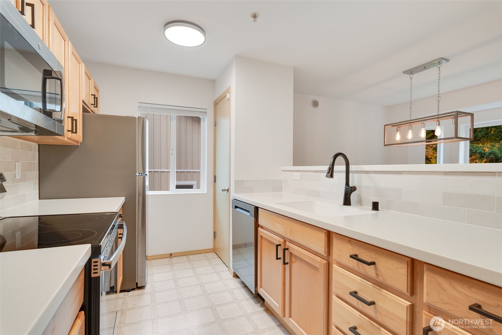 805 Harrington Place Southeast, Unit 3143 Renton, WA 98058 - Photo 2 of 25 a kitchen with a sink and a refrigerator