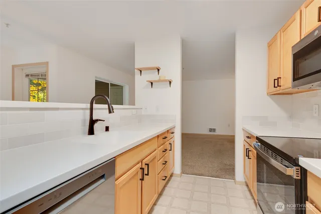 a kitchen with a sink and a stove top oven