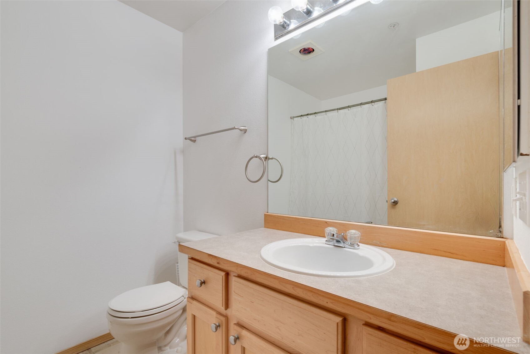 805 Harrington Place Southeast, Unit 3143 Renton, WA 98058 - Photo 10 of 25 a bathroom with a granite countertop sink toilet and a mirror