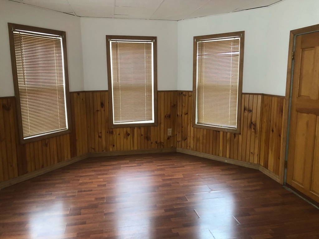 21 Whipple Street, Unit 3 Worcester, MA 01607 - Photo 7 of 8 an empty room with wooden floor and windows