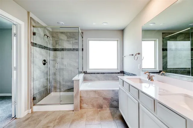 a spacious bathroom with a granite countertop tub shower and sink