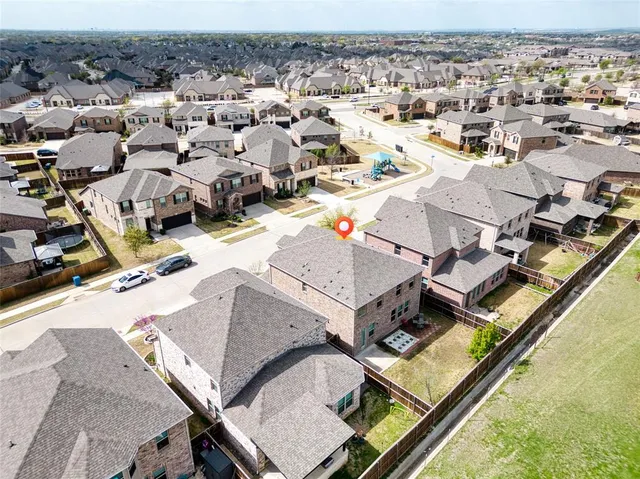 an aerial view of a residential houses with outdoor space