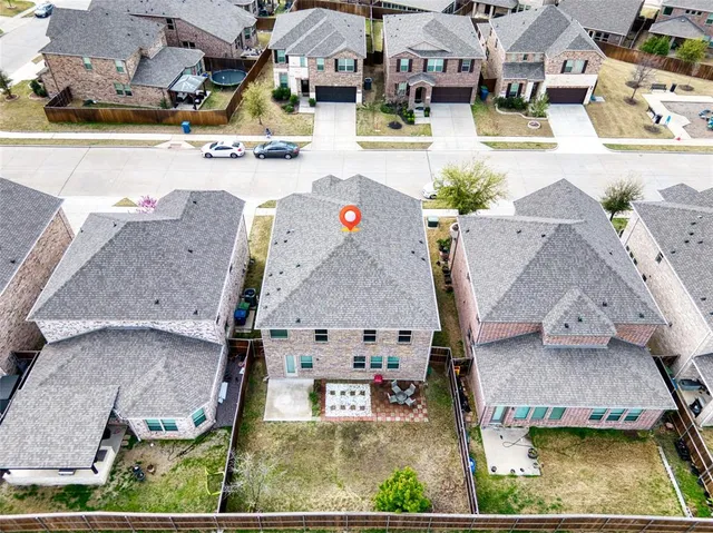 an aerial view of residential houses with outdoor space