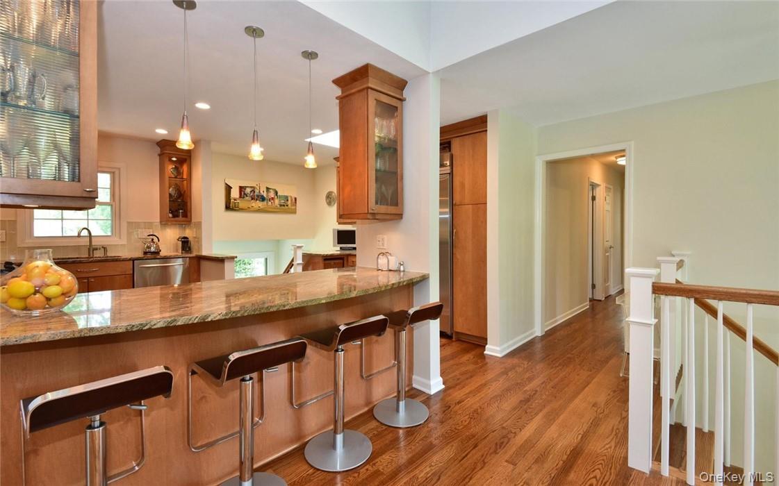 9 Franklin Avenue Rye, NY 10580 - Photo 8 of 35 a dining hall with stainless steel appliances granite countertop a sink and wooden floor