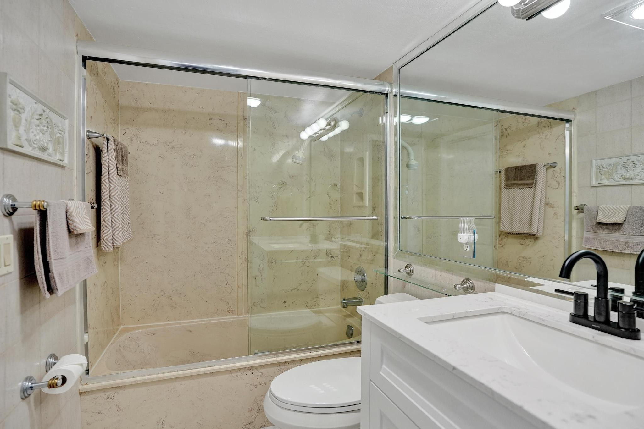 505 North Riverside Drive, Unit 7 Pompano Beach, FL 33062 - Photo 16 of 43 a bathroom with a sink mirror toilet and bathtub