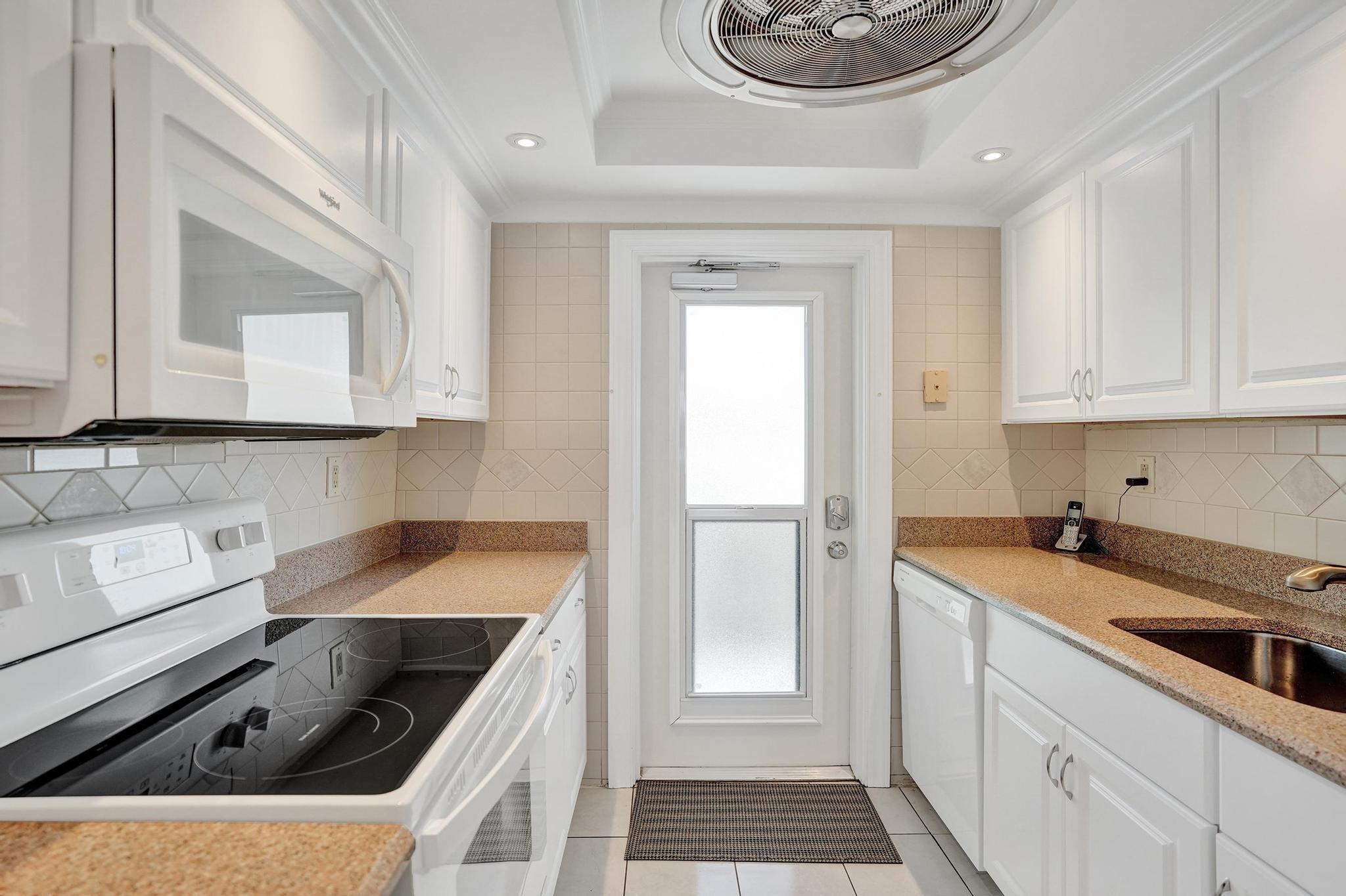 505 North Riverside Drive, Unit 7 Pompano Beach, FL 33062 - Photo 10 of 43 a kitchen with a sink stove and cabinets