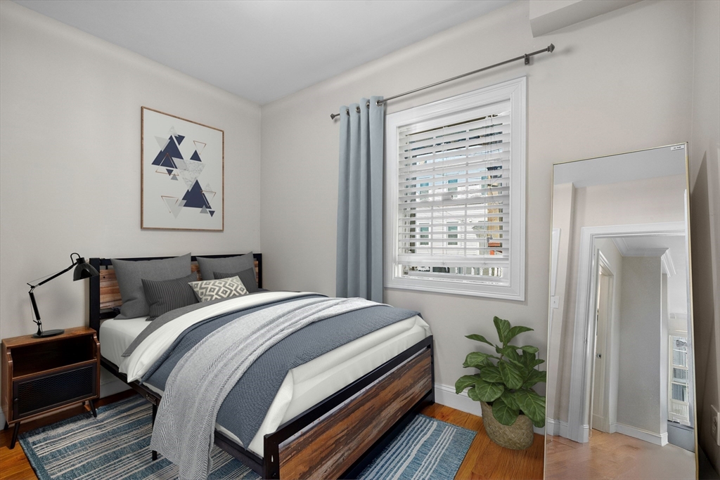110 Chelsea Street, Unit 1 Boston, MA 02128 - Photo 5 of 12 a bedroom with bed and a window