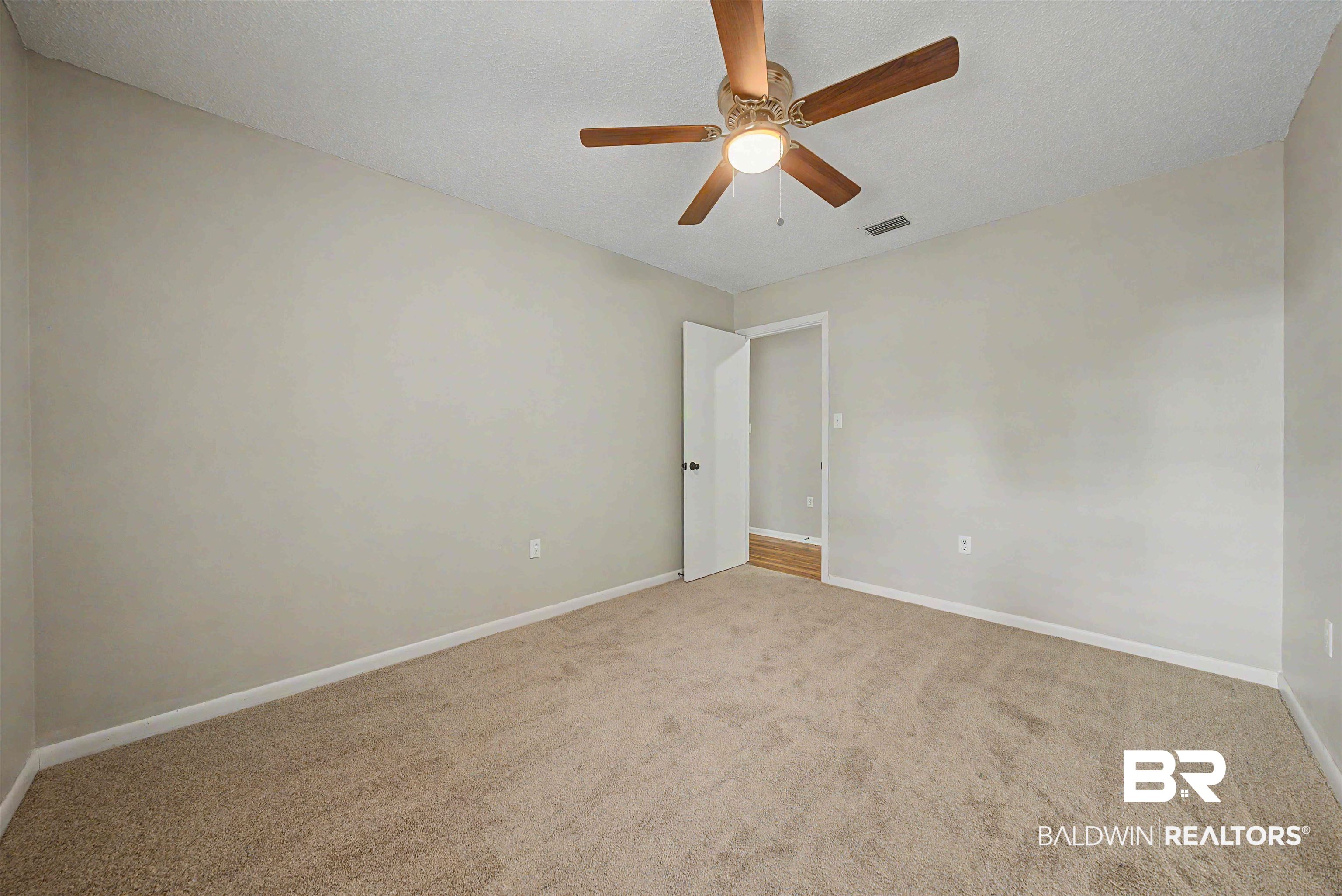 22963 Highway 98 Foley, AL 36535 - Photo 21 of 52 Carpeted room featuring a ceiling fan with light fixture, neutral wall paint, and white trim