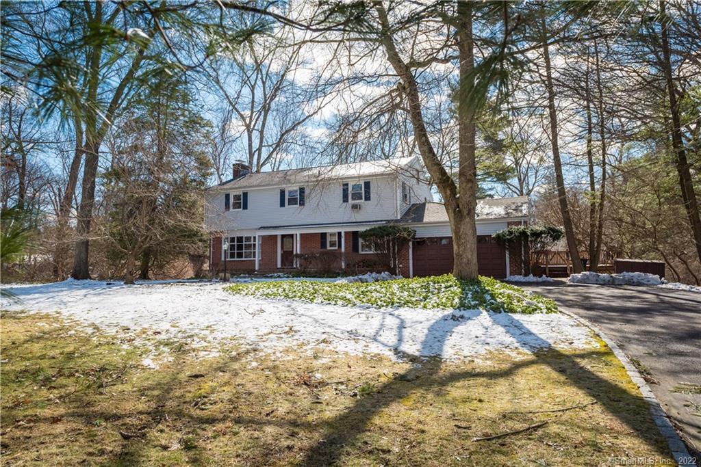 a house that has a tree in front of it
