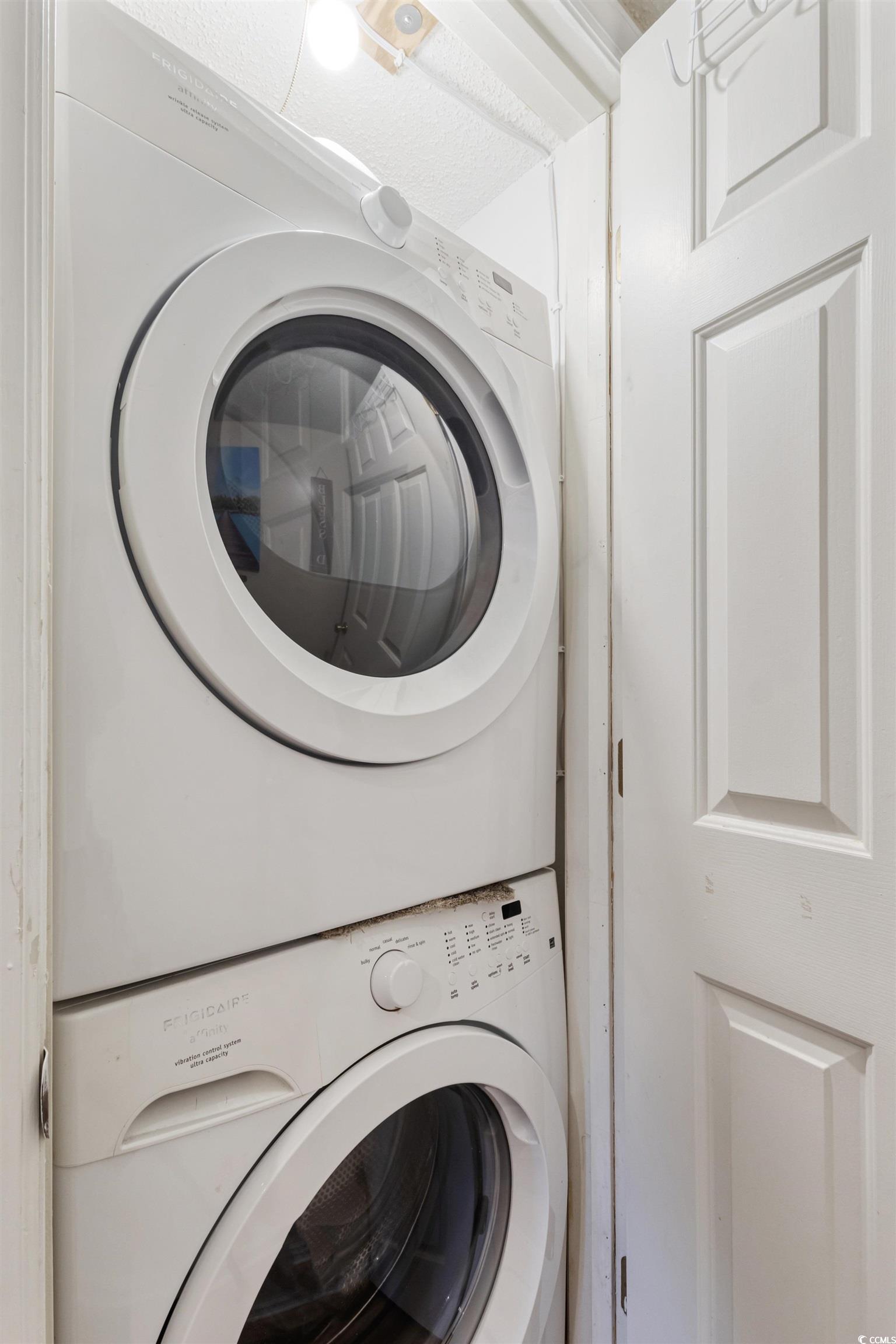 4242 Pinehurst Circle, Unit N3 Little River, SC 29566 - Photo 17 of 30 Laundry area featuring stacked washer / dryer