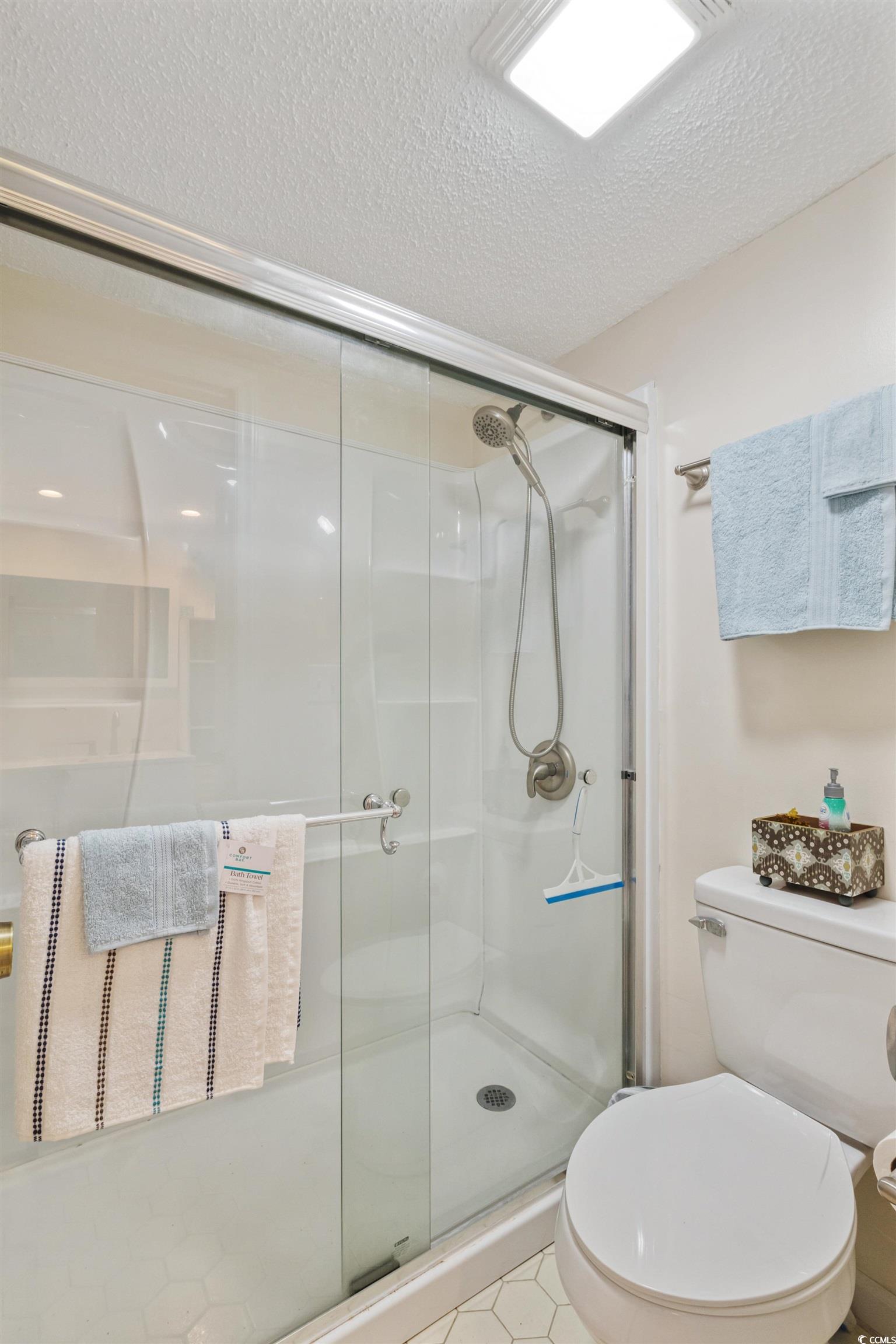 4242 Pinehurst Circle, Unit N3 Little River, SC 29566 - Photo 24 of 30 Bathroom with a textured ceiling, a stall shower, and tile patterned floors