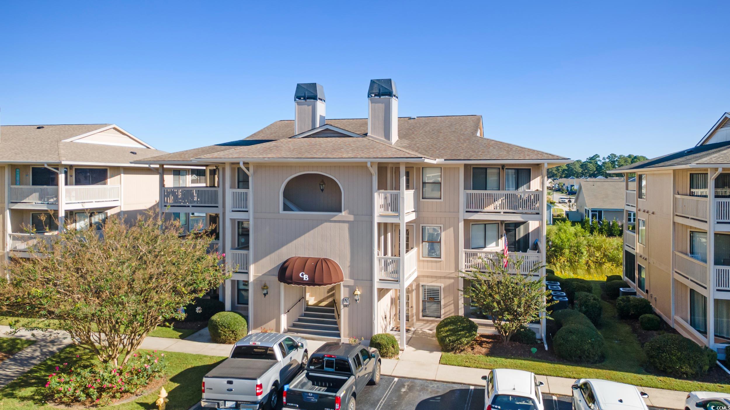 4242 Pinehurst Circle, Unit N3 Little River, SC 29566 - Photo 3 of 30 View of apartment building / complex with uncovered parking