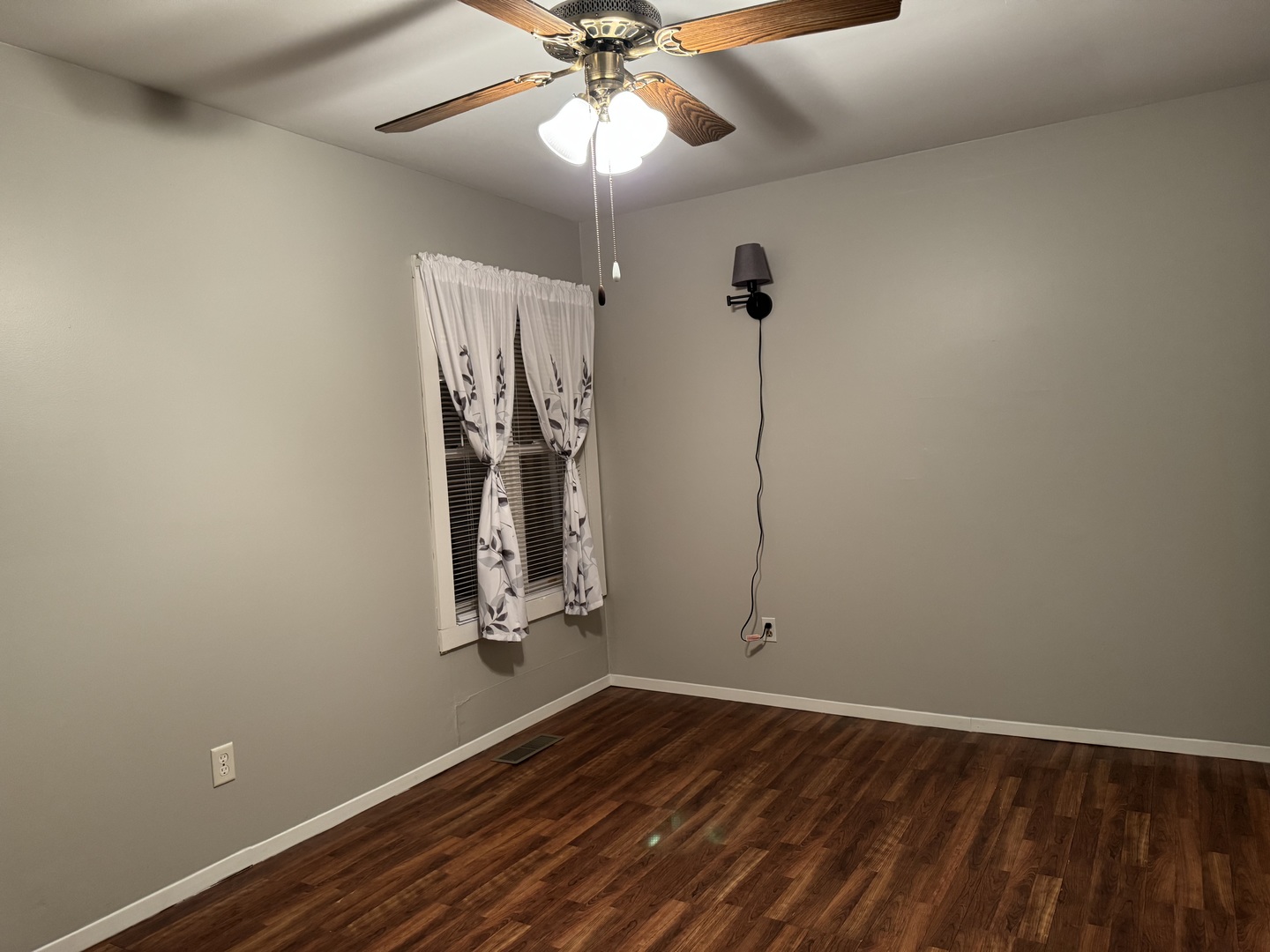 910 West Kennedy Road Braidwood, IL 60408 - Photo 15 of 23 an empty room with wooden floor fan and windows