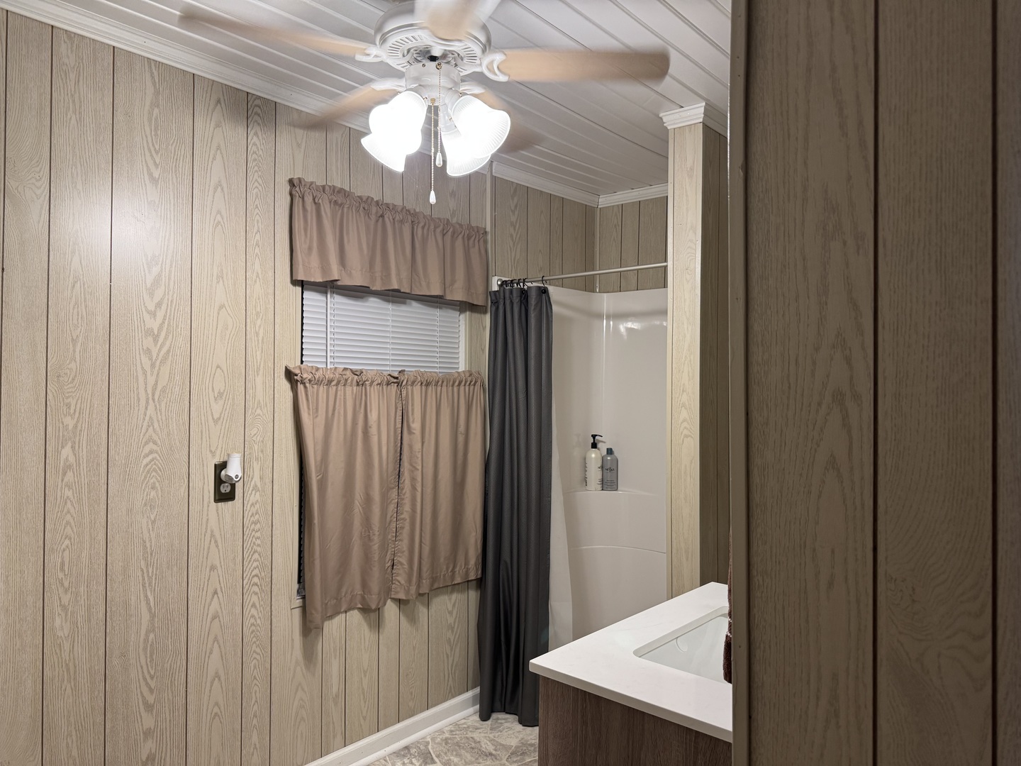 910 West Kennedy Road Braidwood, IL 60408 - Photo 19 of 23 a view of a hallway with a chandelier fan and a bathroom