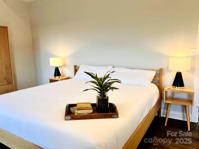 a bedroom with a bed and a flat screen tv