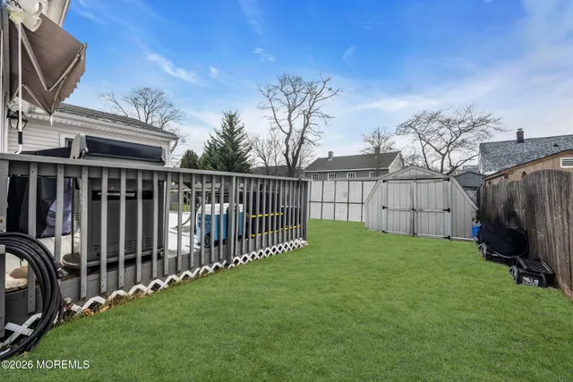 a view of a backyard with wooden fence