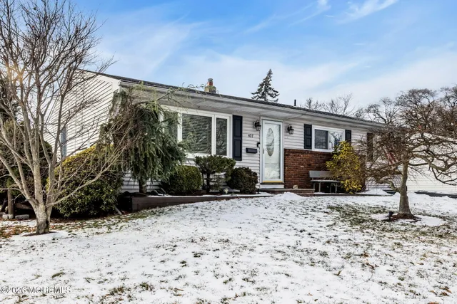 a view of a house with a yard covered in snow